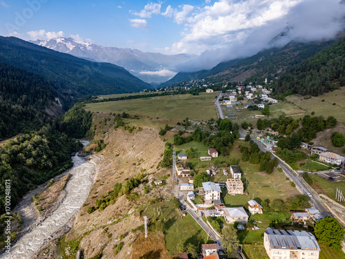 Mestia, Georgia, revealing its breathtaking landscape with houses, river, and majestic mountains