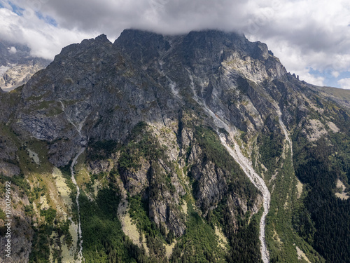 Aerial view of rocky mountains covered by clouds in Mestia, Svaneti, Georgia