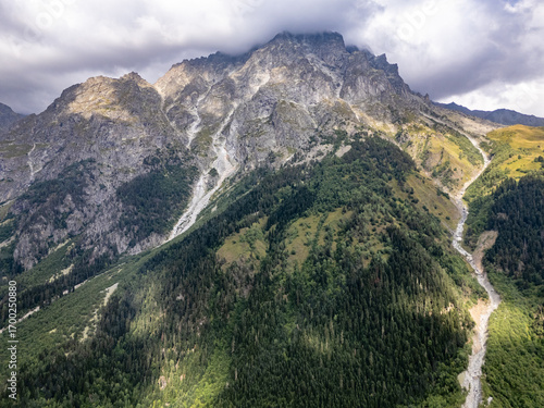 Aerial view of rocky mountains covered by clouds in Mestia, Svaneti, Georgia