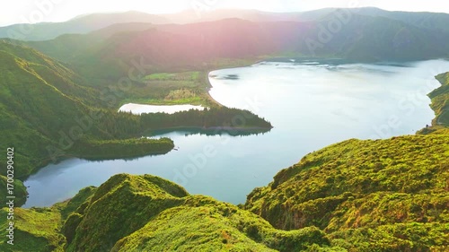 Lagoa do Fogo Crater Lake at Sunrise. Green Lush Hills. Azores, Sao Miguel Island. Portugal. Aerial View. Drone Moves Forward and Down