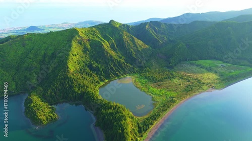 Lagoa do Fogo Lake on Sunny Morning. Green Lush Hills and Mountains. Azores, Sao Miguel Island. Portugal. Aerial View. Drone Moves Back