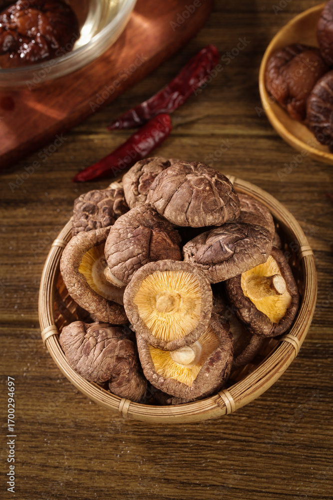 Fototapeta premium Dried Shiitake Mushrooms in Bamboo Basket - Asian Cooking Ingredients Still Life