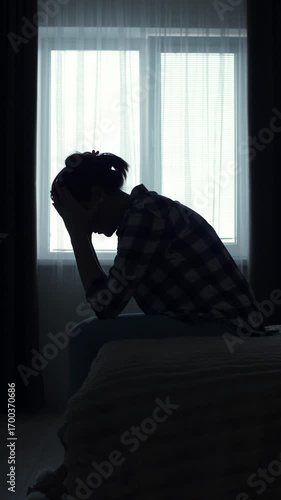 A woman’s silhouette sits alone in a dark bedroom, deep in thought. She feels depressed, lost, and emotionally overwhelmed. A cinematic moment of inner struggle and mental health crisis.