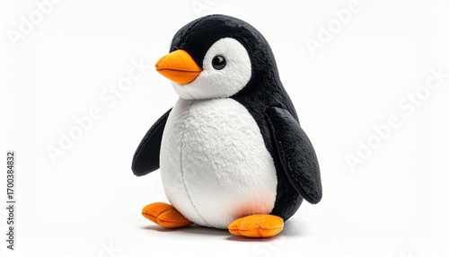Plush penguin toy with black and white soft fabric orange beak stitched details round stuffed body and huggable design created as a cute children cuddly toy isolated on white background
