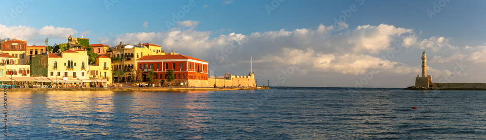 Obraz premium Panoramic view of the Venetian Harbor in Chania on Crete island in Greece with colorful buildings and the lighthouse.