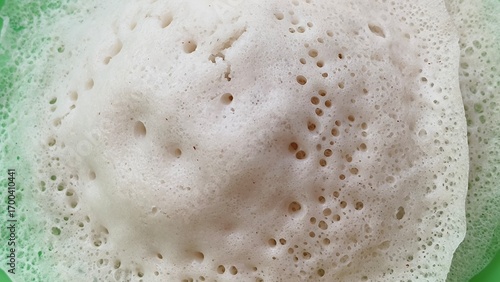 Appam, kalappam, vellayappam or palappam popular traditional rice flour vegetarian dish for breakfast and dinner in south Indian states Karnataka, Tamil Nadu and Kerala. Closeup macro top view.