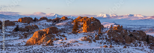 This panorama features the soft, last light of a winter day illuminating the rock formations of Hartman Rocks in Gunnison, Colorado.