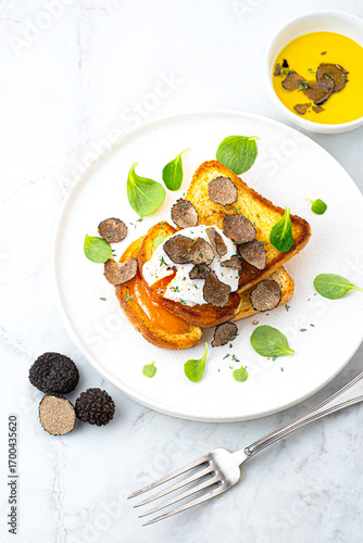 Wallpaper Mural Poached egg with black truffle on crispy buttered bread. Truffle breakfast, French cuisine, simple gourmet recipes. Autumn gourmet cuisine of Piedmont, Northern Italy, France, Spain Torontodigital.ca