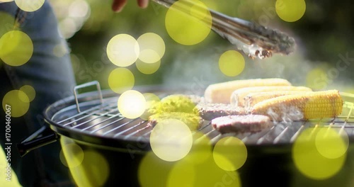 Stepping into frame gripping tongs, chef flipping patties rotating corn for even cooking bbq grill