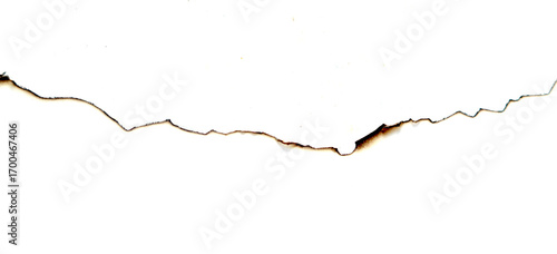Black-brown burn marks on the edge of white paper