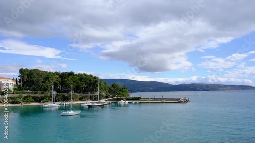 Wallpaper Mural Krk, Croatia - March 30 2025. Krks marina approaches, highlighting sailboats gently rocking in water. Travel to Krk island in Primorje-Gorski Kotar County of western Croatia Torontodigital.ca