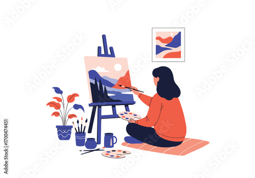 Artist painting a landscape on canvas with colorful paints and brushes surrounded by plants and art supplies on the floor