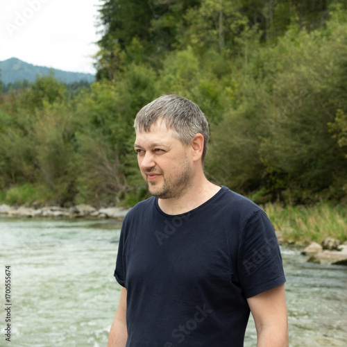 Portrait of a handsome strong European man in nature.