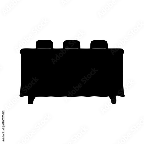Silhouette of long table with three chairs draped with tablecloth