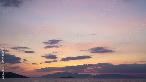 Tranquil Sunset Over the Sea with Islands and Clouds
