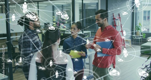 Collaborating team of five discussing project in office, with colored folders and network icons