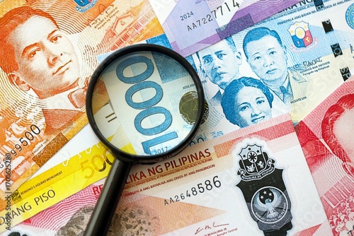 Photos Philippines peso currency money bills and magnifying glass