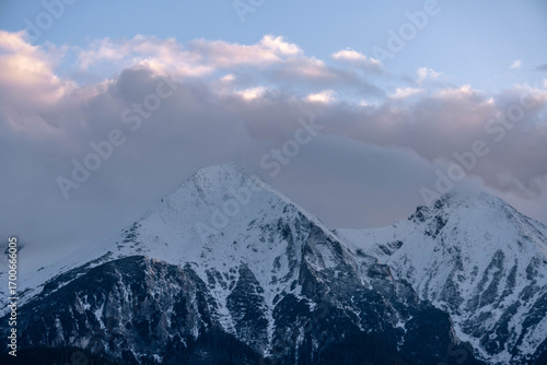 Fototapeta Naklejka Na Ścianę i Meble -  snow covered mountains tatry poland with clouds around and big pine trees