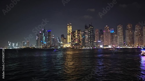 Wallpaper Mural Bright city skyline at night with waterfront boats and shimmering lights in Dubai Torontodigital.ca