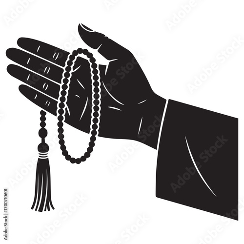 Close up of a silhouetted hand holding a string of prayer beads with a tassel symbolizing faith and devotion