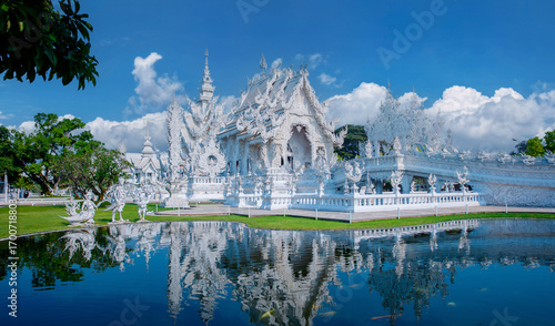 Panorama White temple wat rong khun reflecting in pond, Chiang Rai, travel landmark of Thailand