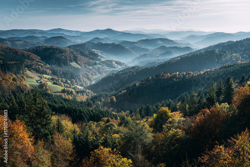Majestic autumnal mountain landscape rolling hills and valleys covered in colorful forests misty atmosphere