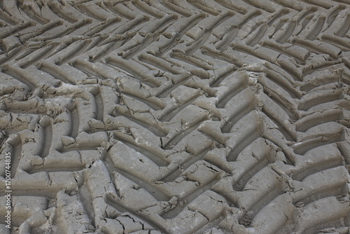 View from above on many deep tire tracks in the sand	