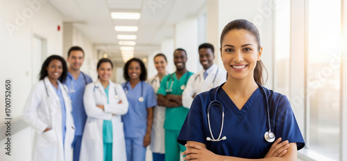 Commercial Photo of Smiling Doctor with Diverse Medical Team in Bright Modern Hospital for healthcare marketing, hospital advertising, medical campaign visuals, professional stock image, healthcare