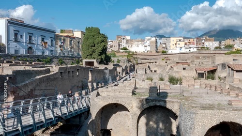 Timelapse of visitors walking through the narrow ancient streets of Herculaneum, the Roman city destroyed by the eruption of Mount Vesuvius in 79 AD. Naples, Italy.