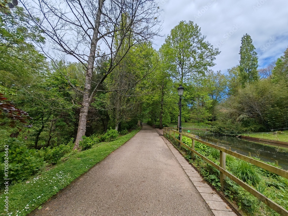 Fototapeta premium Pathway along canal in green park
