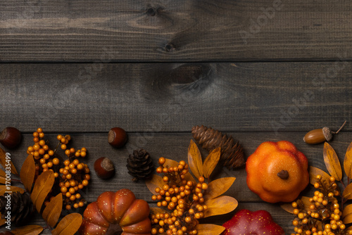 Autumn pumpkins and leaves on wooden background.