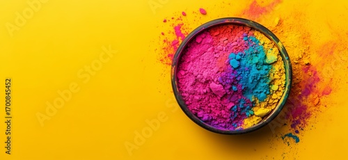 Vibrant Color Powders in a Bowl Against a Bright Yellow Background for a Fest...