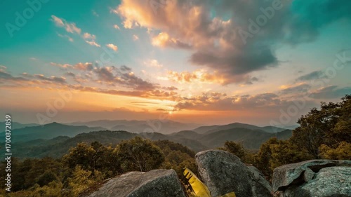 Beautiful sunrise over the mountains with clouds and sun rays in the sky