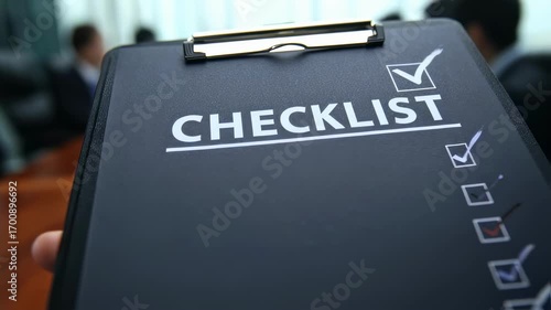 Medium shot centered on a gutcheck checklist for corrective actions foreground clear blurred colleagues taking notes behind.