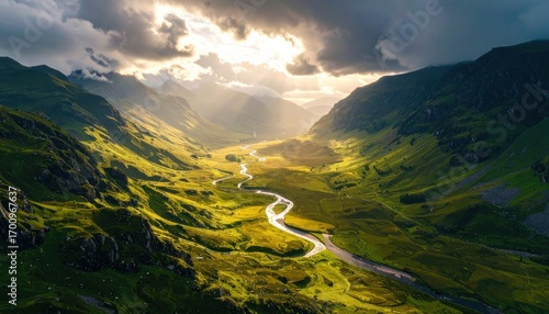 Dramatic sunlight shines on Scottish Glen Coe valley landscape.
