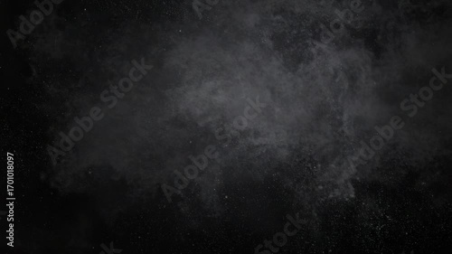 Slow motion shot of a billowing smoke cloud on a dark background with scattered particles for abstract moody effect, mysterious atmospheric feeling
