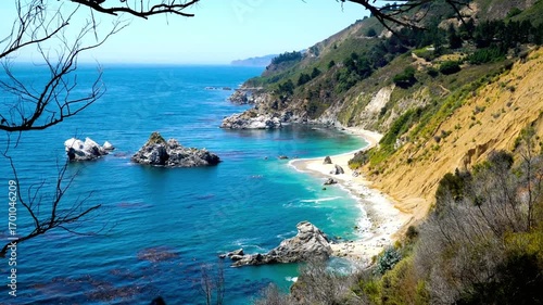 Big sur coastline in california with rocky cliffs and blue water on a sunny day