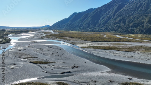 Surrounded by mountain ranges the Turiwhate River flows through farming fields on the road to Arthurs Pass