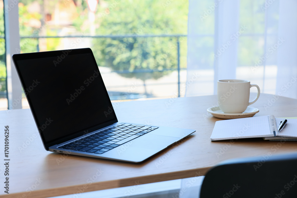 Fototapeta premium Home workspace. Modern laptop and stationery on wooden desk indoors