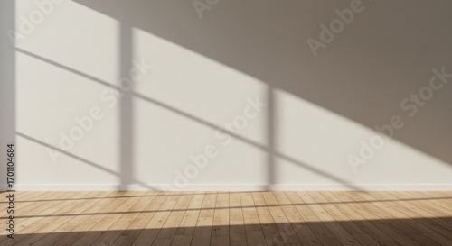 Sunlight streams into a minimalist room, casting stark shadows on the wall and wooden floor.
