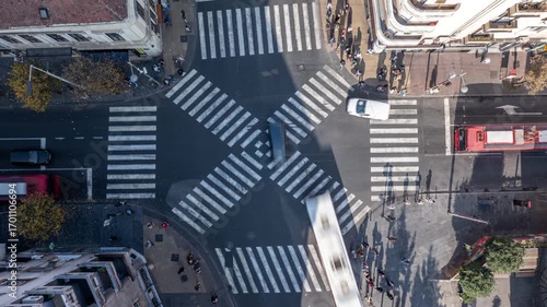 Overhead perspective of a city intersection with zebra crossings and surrounding buildings.