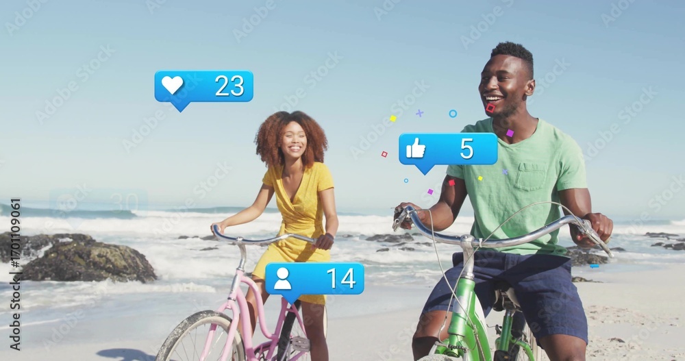 Fototapeta premium Friends pedaling pink, green bikes on beach with rocky outcrops, with blue notification icons