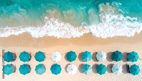 A high-angle view of a beautiful beach, showcasing rows of teal and white beach umbrellas, gently lapping waves, and soft, golden sand.