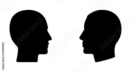 black silhouettes of human heads facing each other. set of human heads facing each other