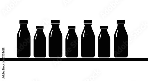 Silhouette of seven milk bottles of varying sizes, lined up on a shelf against a white background.