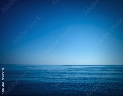 A serene body of water  reflecting the vibrant blue sky above  surrounded by lush greenery and gentle ripples  inviting tranquility and peace.