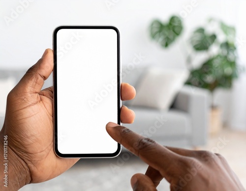 Hand holding smartphone with blank white screen mockup. Generated image