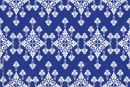 Motif ethnic ikat pattern seamless textile. Antique pattern, white flowers, navy blue background.