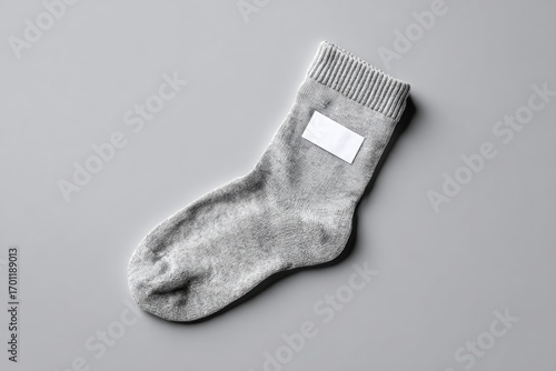 Gray sock with blank label on gray background