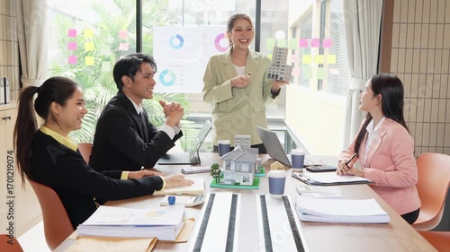 Asian real estate businessmen and home sales agents meet with clients and introduce new home models to Asian buyers investing in real estate business concepts.VDO Slow Motion